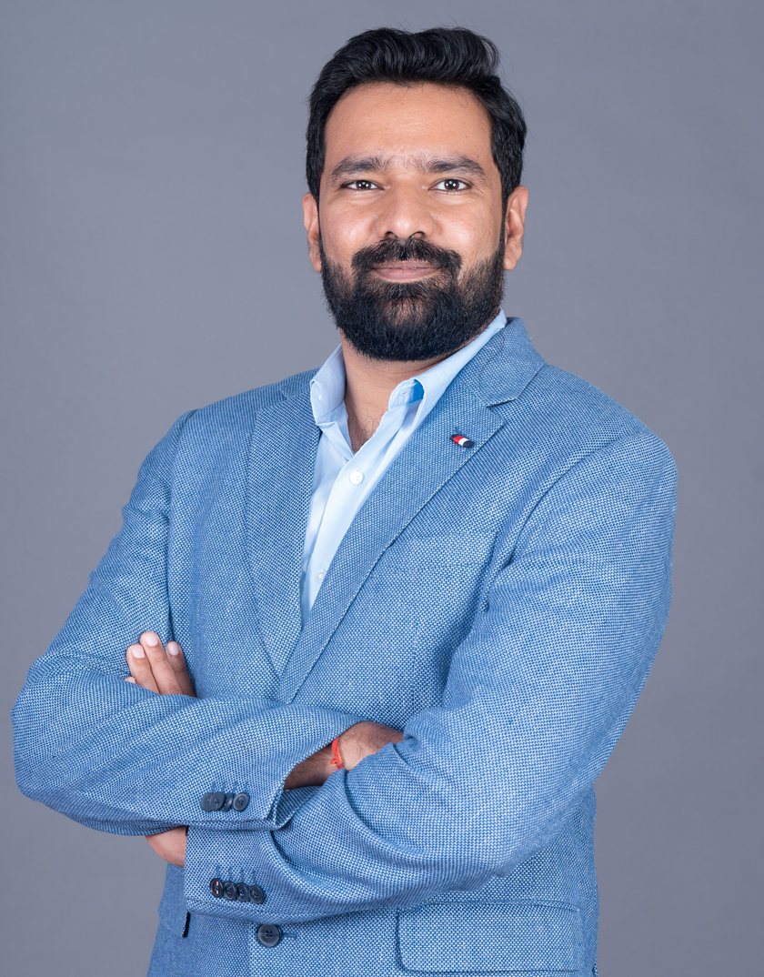 Ajay Saini — arms crossed, ready to talk.